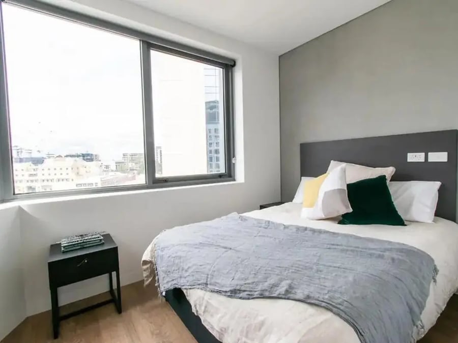 Bed with pillows and throw nightstand bedroom at Yugo University Square Melbourne in Melbourne Student Accommodation