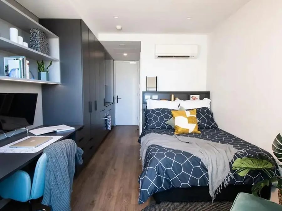 Bed desk storage wardrobe bedroom at Yugo University Square Melbourne in Melbourne Student Accommodation