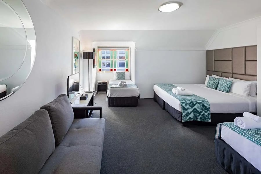 Sofa twin beds queen bed towels living room at ume Redfern Village in Sydney Student Accommodation