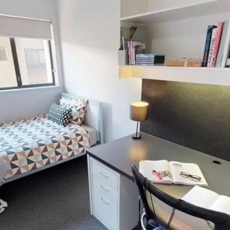 Bed desk lamp books and window bedroom at ECU Villlage Mount Lawley in Perth Student Accommodation
