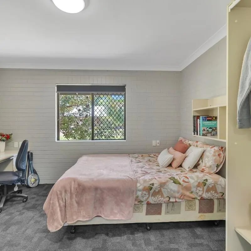 Bed desk chair and wardrobe bedroom at Murdoch University Village in Perth Student Accommodation