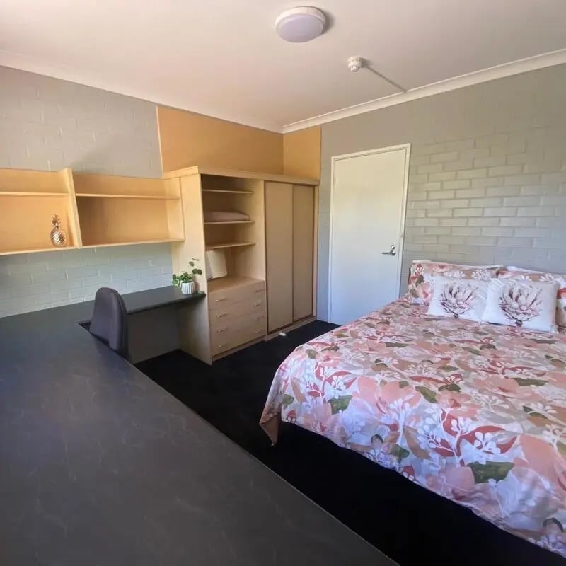 Bed desk wardrobe and shelves bedroom at Murdoch University Village in Perth Student Accommodation