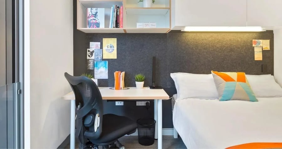 Desk chair bed and pillows bedroom at Iglu Central in Sydney Student Accommodation