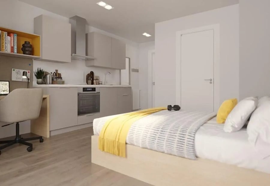 Bed desk kitchen and white door bedroom at Brigg Point in Bristol Student Accommodation
