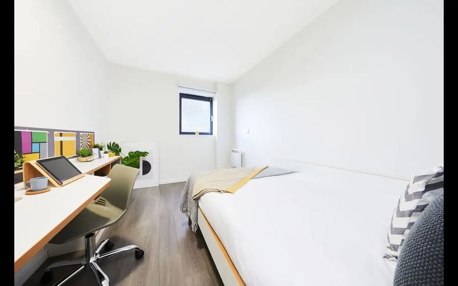 Bed desk and chair student accommodation bedroom at Collegiate Merlin Heights in Leicester Student Accommodation