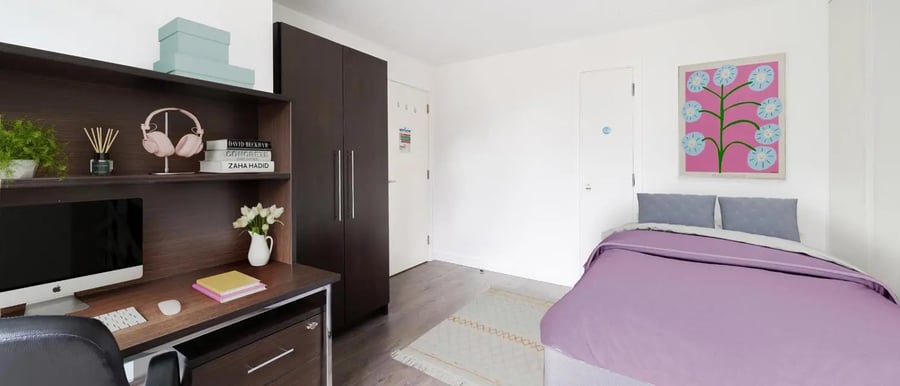 Desk headphones computer bed and painting bedroom at Chapter Spitalfields in London Student Accommodation