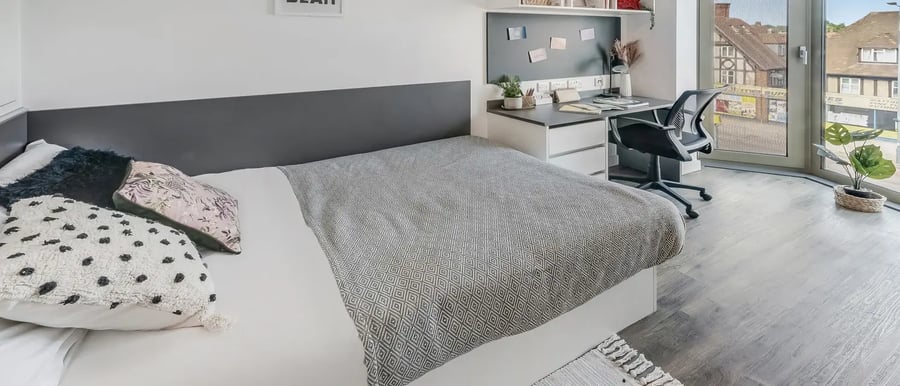 Bed desk chair and plant bedroom study area at Chapter White City in London Student Accommodation