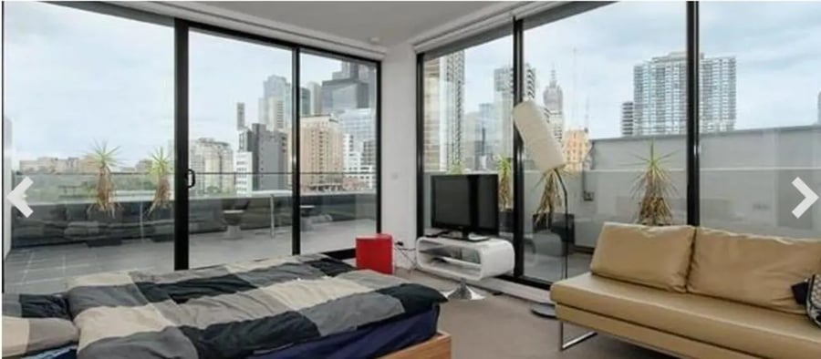 Bed TV sofa balcony with city view bedroom at Student Living D2 in Melbourne Student Accommodation