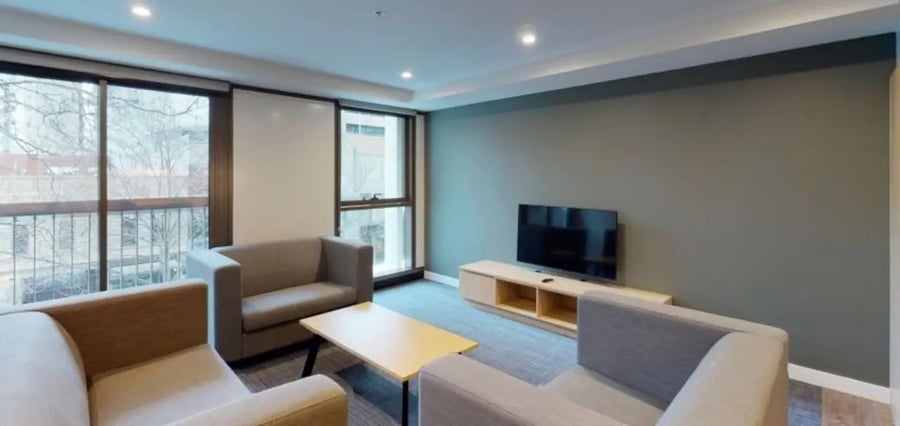 Sofas coffee table television living room at Unilodge Melbourne City in Melbourne Student Accommodation