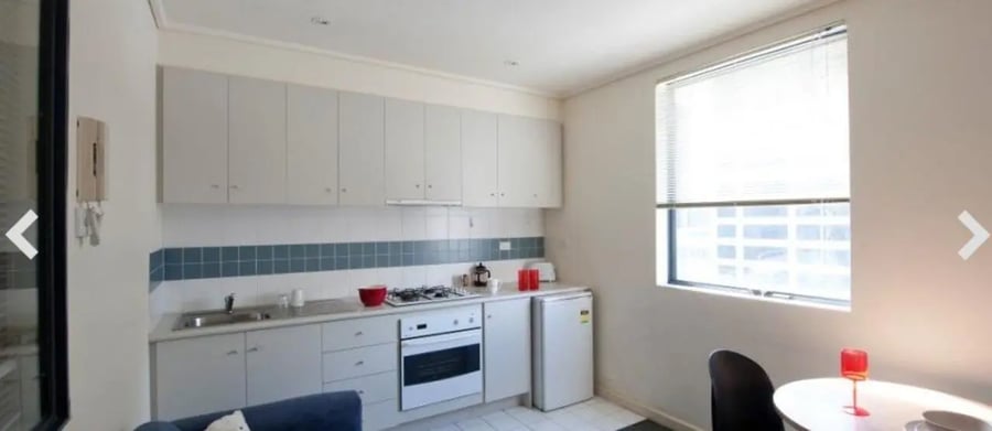 Kitchen with cabinets sink stove and fridge kitchen at Student Living On ABeckett in Melbourne Student Accommodation