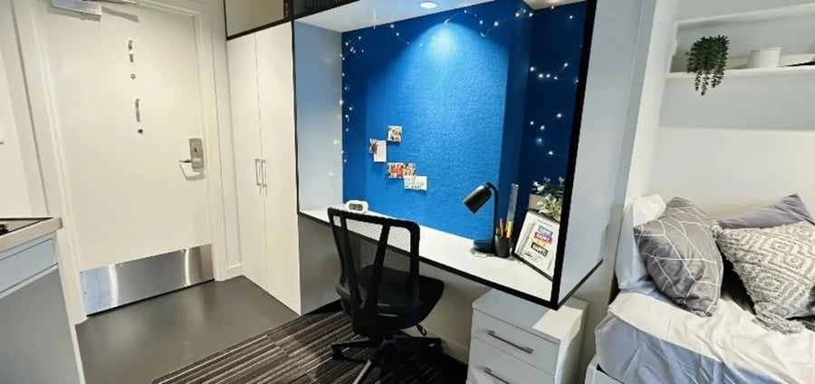 Desk chair blue wall fairy lights bed Bedroom at UniLodge Auckland City in Auckland Student Accommodation