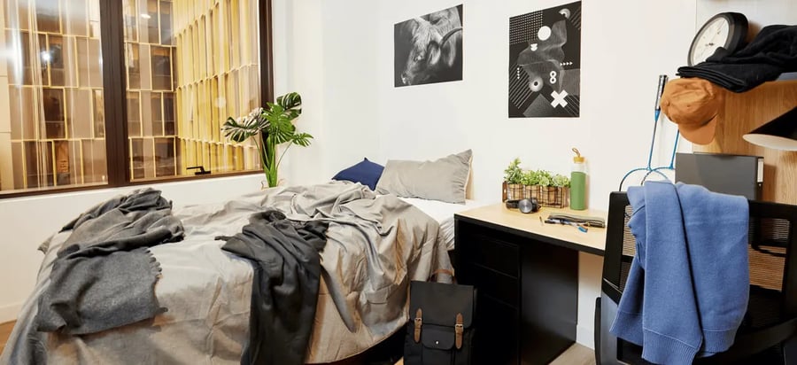Bed desk plants artwork and clock bedroom at Scape La Trobe in Melbourne Student Accommodation