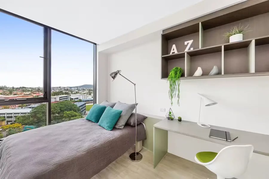 Bed desk and shelves student room interior at Scape Merivale in Brisbane Student Accommodation