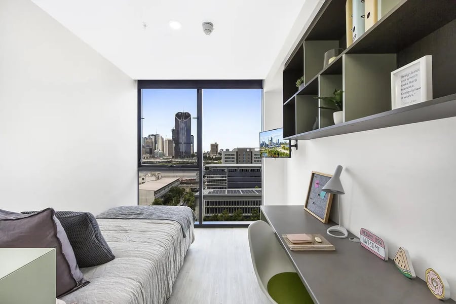 Bed desk shelves window city view bedroom at Scape Merivale in Brisbane Student Accommodation