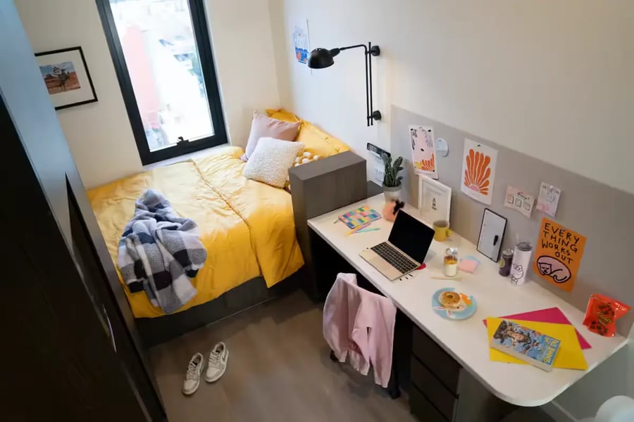 Bed desk laptop decorations and a window bedroom at Scape Cornell Place in Melbourne Student Accommodation