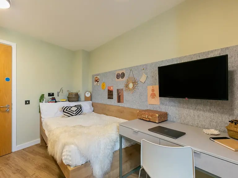 Bed desk TV and chair bedroom at The Curve in London Student Accommodation