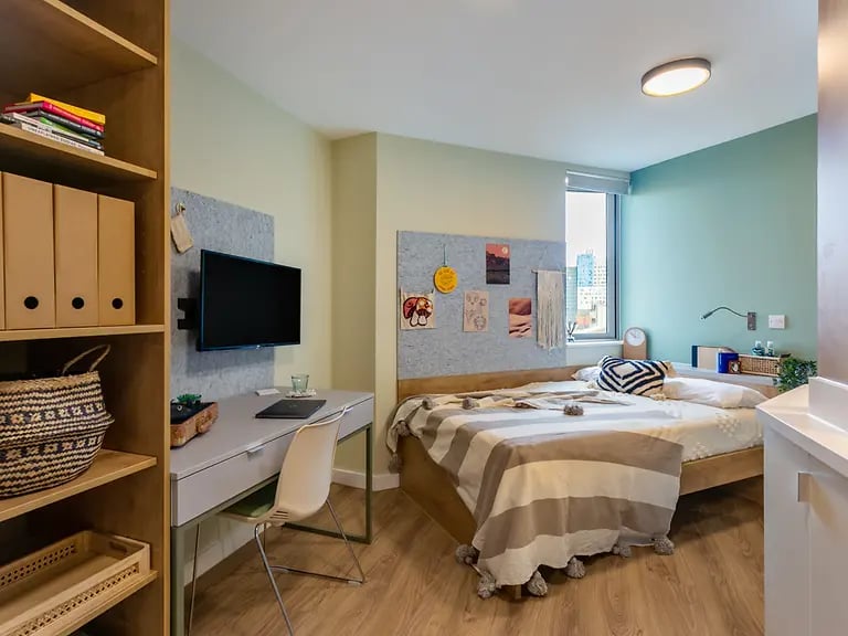 Bed desk shelves TV bedroom at The Curve in London Student Accommodation