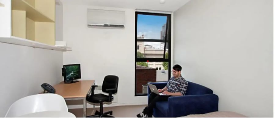 Desk with computer and sofa bedroom at Student Living On Campus in Melbourne Student Accommodation