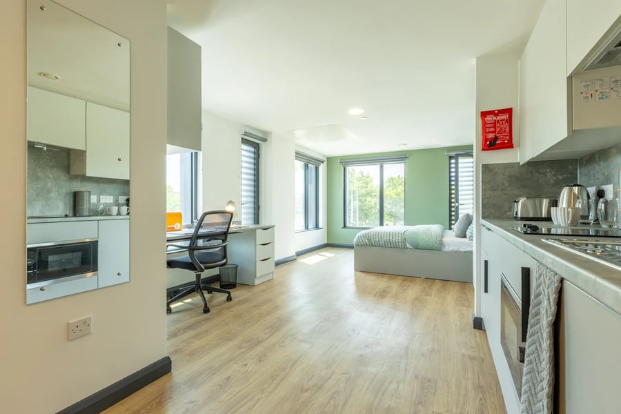 Studio apartment with bed desk and kitchen at Winfield Court in Nottingham Student Accommodation