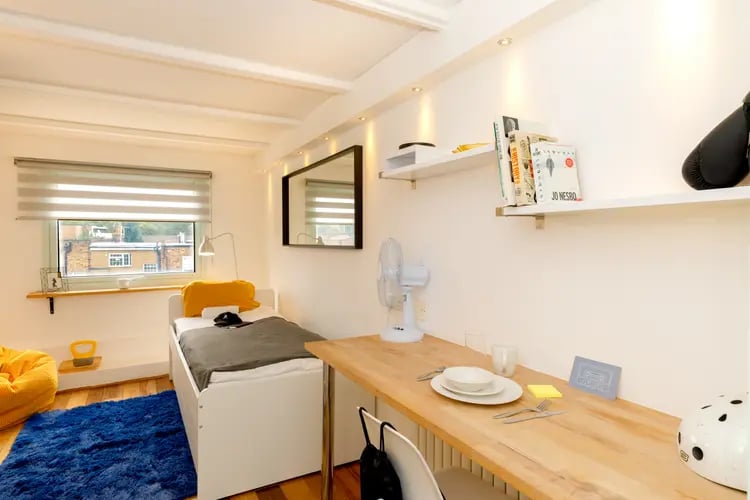 Bed desk fan and boxing glove bedroom at The Stay Club - Camden in London Student Accommodation
