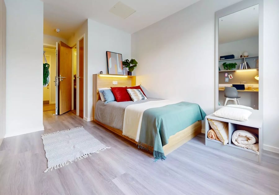 Bed study area with desk mirror and storage Bedroom at iQ Sterling Court in London Student Accommodation