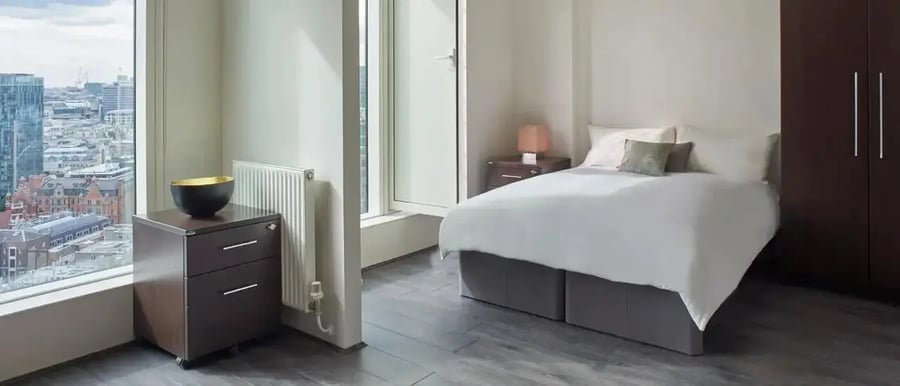 Bed nightstand wardrobe with city view bedroom at Chapter Spitalfields in London Student Accommodation
