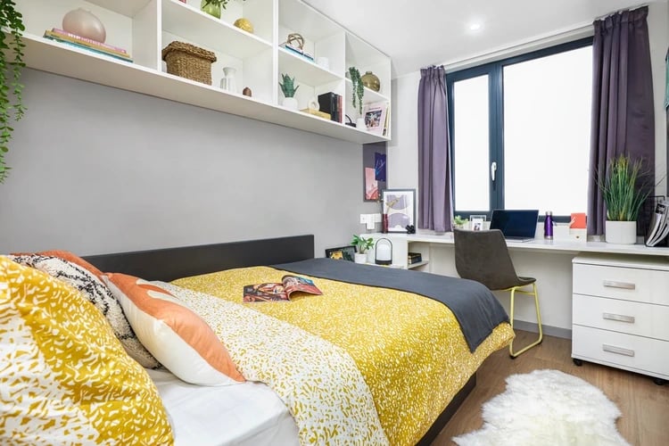 Bed desk shelves with books and laptop bedroom interior at Staniforth House in Birmingham Student Accommodation