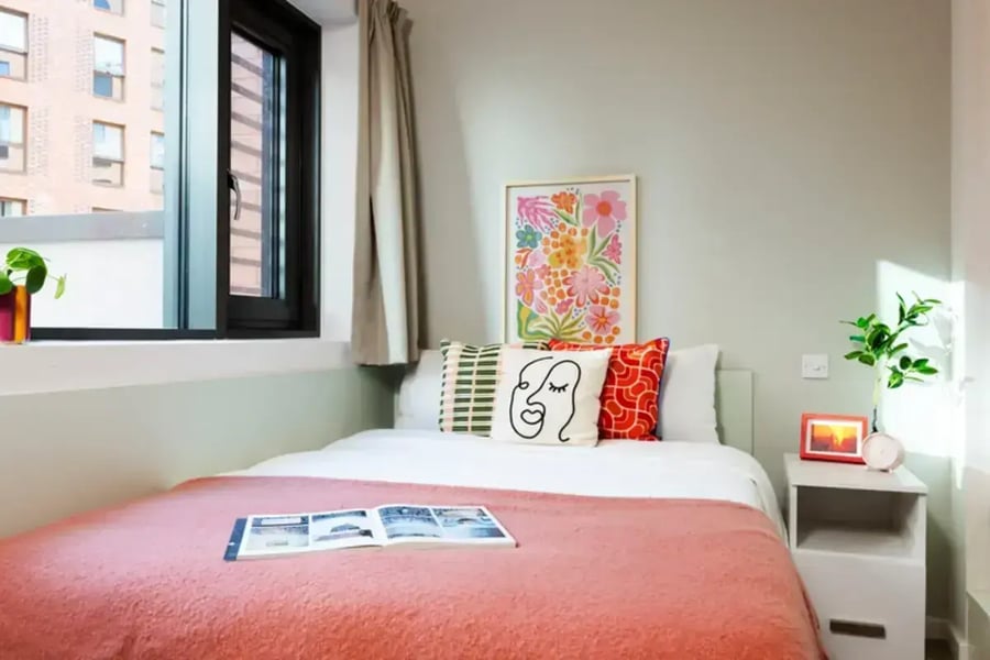 Bed with decorative pillows and art Bedroom at Avon Point in Bristol Student Accommodation