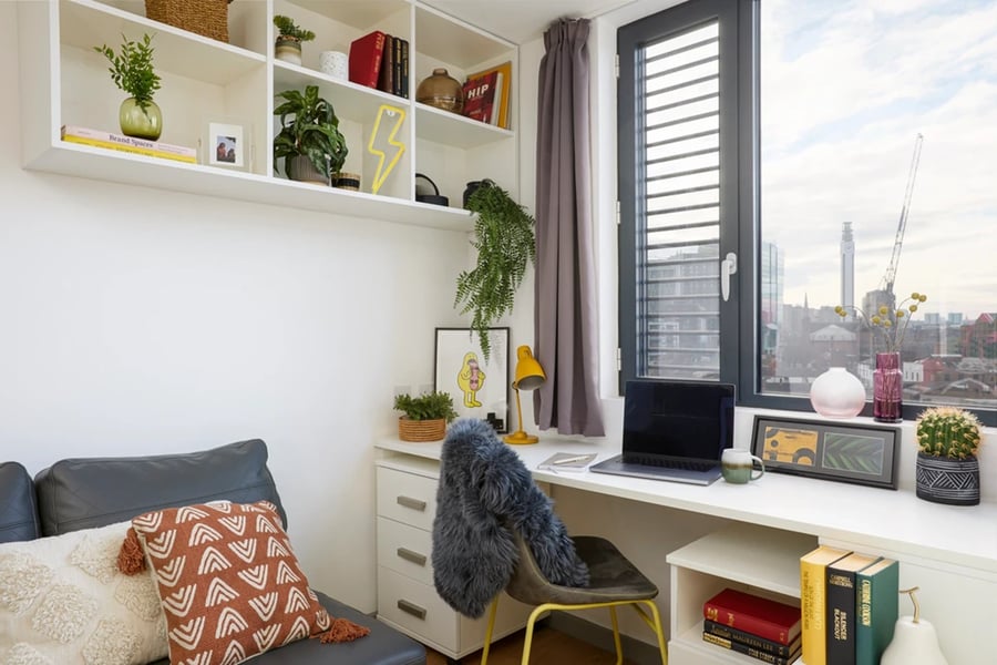 Desk chair shelves laptop and cushions study area at Staniforth House in Birmingham Student Accommodation