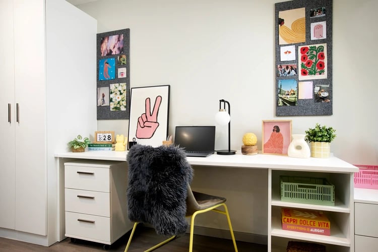 Desk with laptop lamp chair and decor study area at Stapleton House in London Student Accommodation