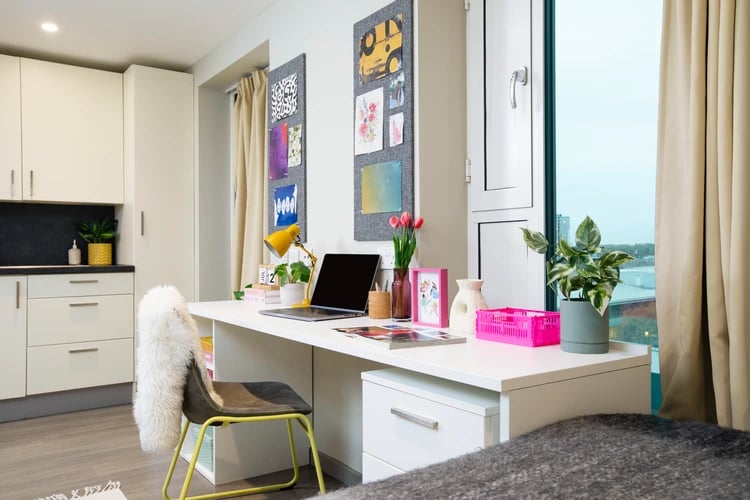 Desk with laptop plant and chair study area at Stapleton House in London Student Accommodation