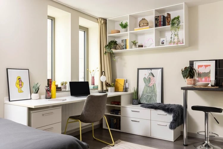 Desk laptop chair shelves artwork study area at Stratford One in London Student Accommodation