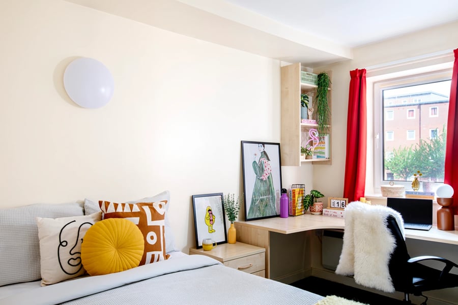 Bed with decorative pillows desk and chair bedroom at Castle Court in Leicester Student Accommodation