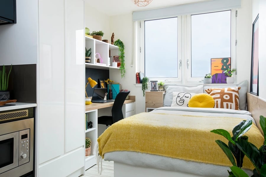 Bed desk shelf microwave kitchen bedroom at Walmsley Studios in London Student Accommodation