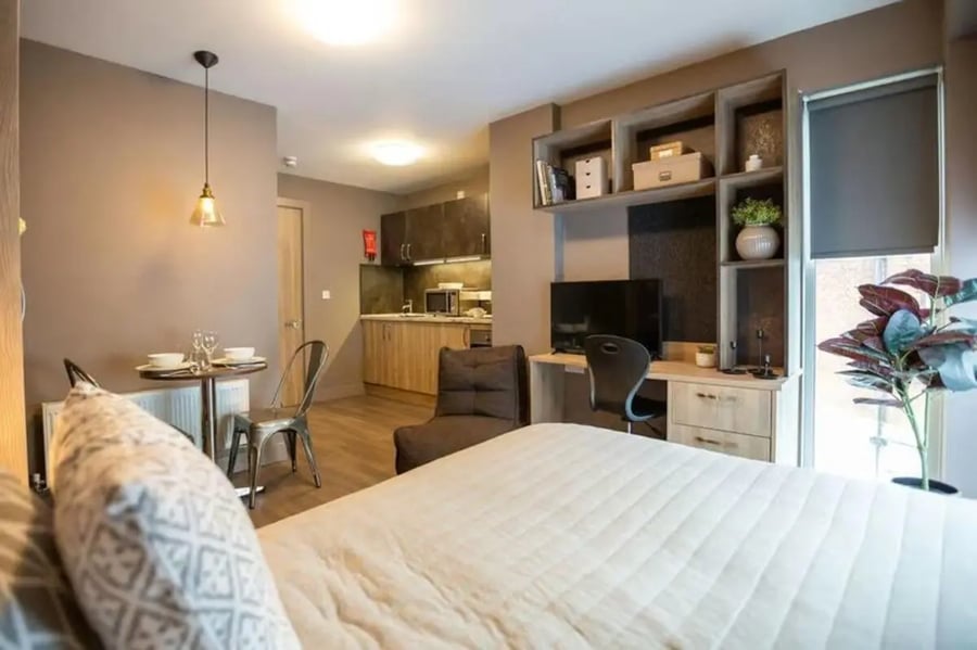 Bed desk small kitchen dining area living room at West Gate in Exeter Student Accommodation