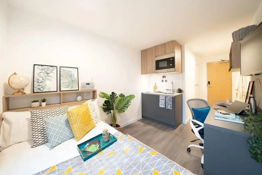 Bed kitchen study area and desk studio apartment at Canvas Walthamstow in London Student Accommodation