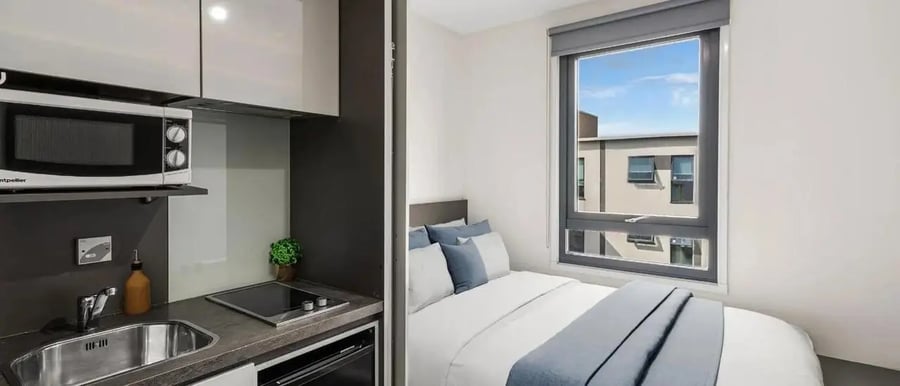 Microwave sink stove bed pillows bedroom kitchen at Chapter Highbury in London Student Accommodation