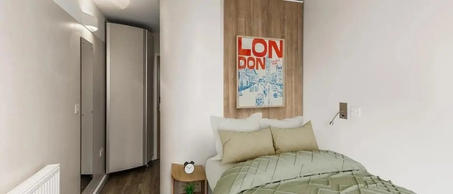 Bed with London art above it Bedroom at Chapter Highbury in London Student Accommodation