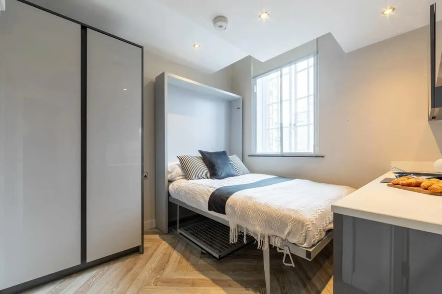 Fold-down bed white linens large closet bedroom at dwell 121 Princess Street in Manchester Student Accommodation