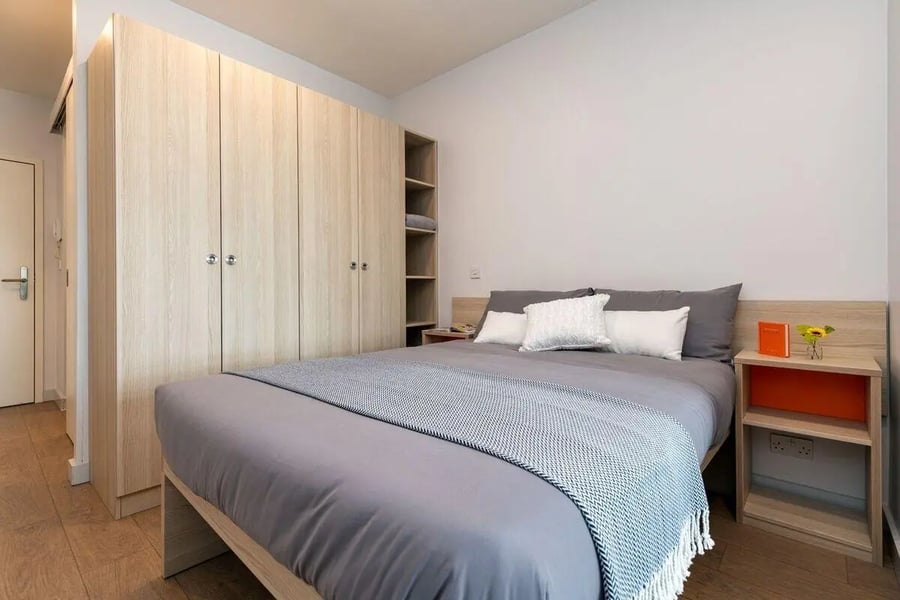 Wardrobe bed and bedside table bedroom at Collegiate Middle Street in Portsmouth Student Accommodation