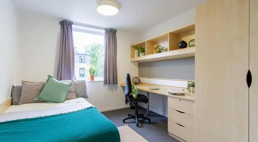 Bed desk chair shelves wardrobe bedroom at The Green in Bradford Student Accommodation