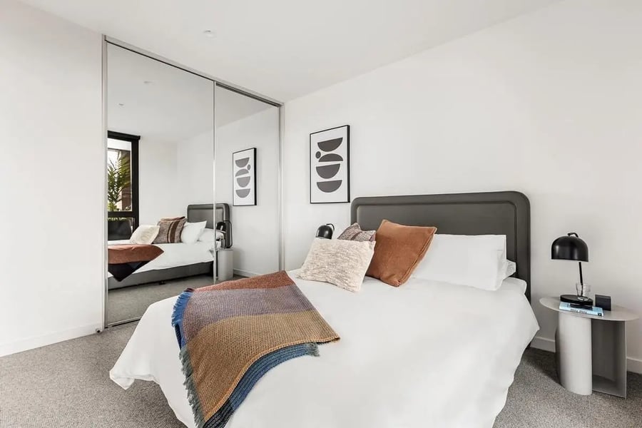 Bed with mirrored wardrobe and art bedroom at Caulfield Place in Melbourne Student Accommodation