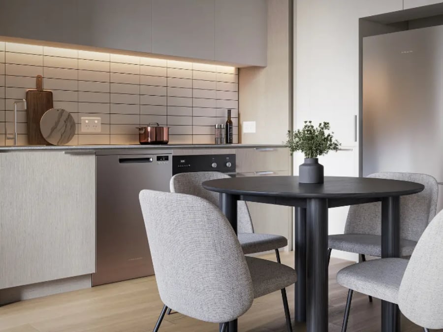 Dining table and chairs with kitchen view. at West Tower, Melbourne Quarter in Melbourne Student Accommodation