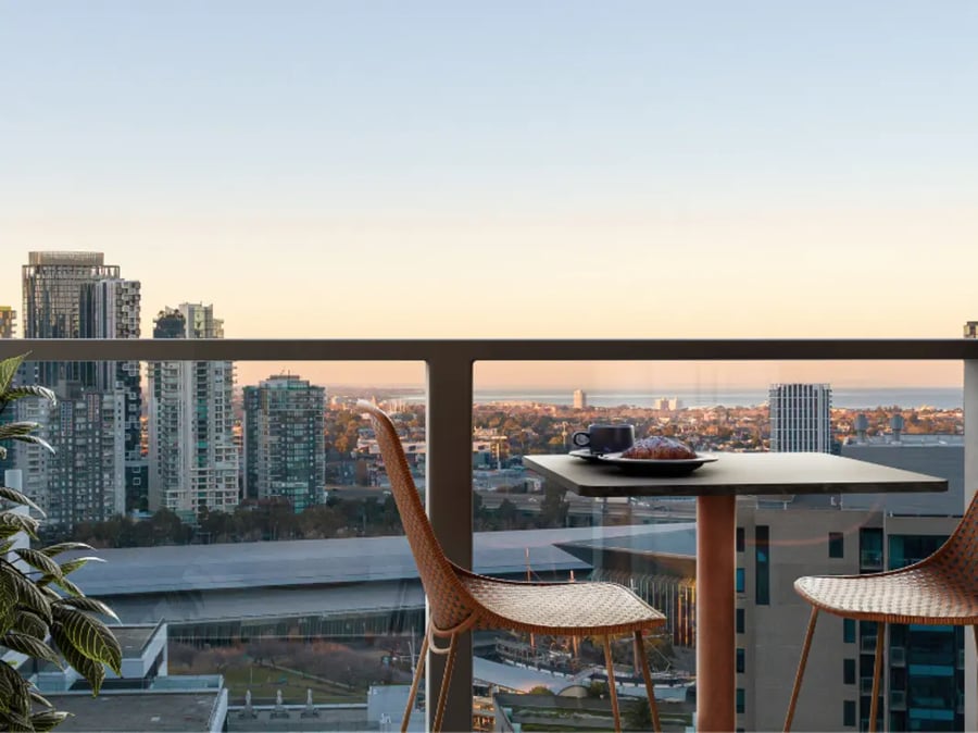 Balcony with table chairs coffee croissant exterior at West Tower, Melbourne Quarter in Melbourne Student Accommodation
