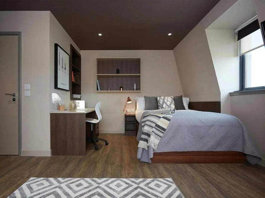 Bed desk chair shelves and rug bedroom at Woodside House in Glasgow Student Accommodation