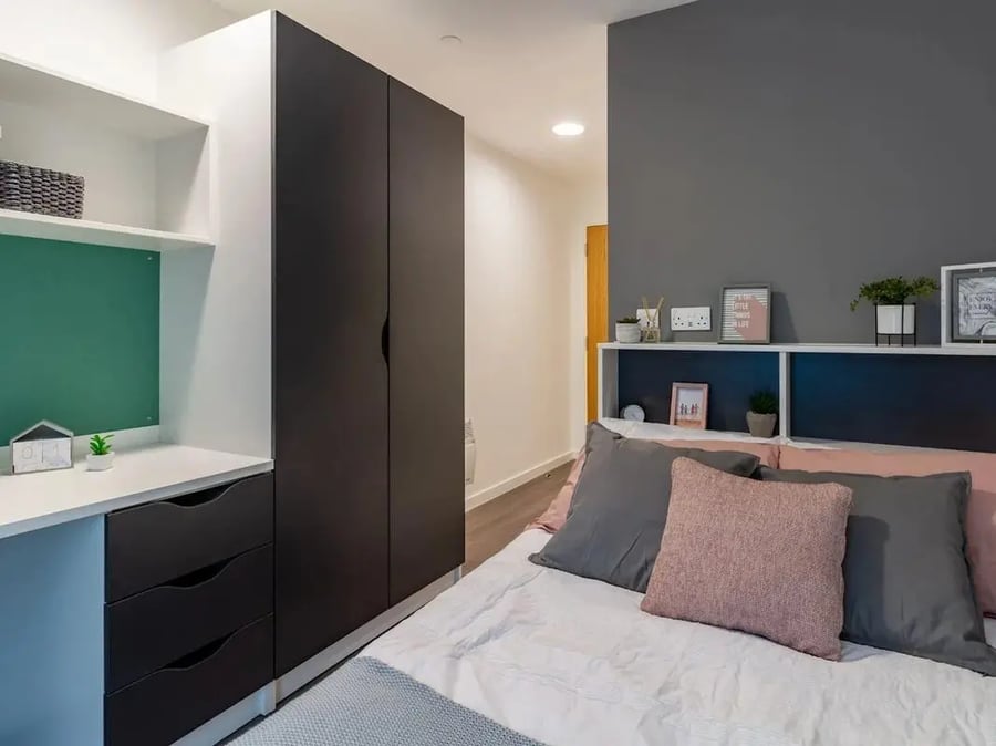 Wardrobe desk and bed with pillows bedroom at Pavilion Court London in London Student Accommodation