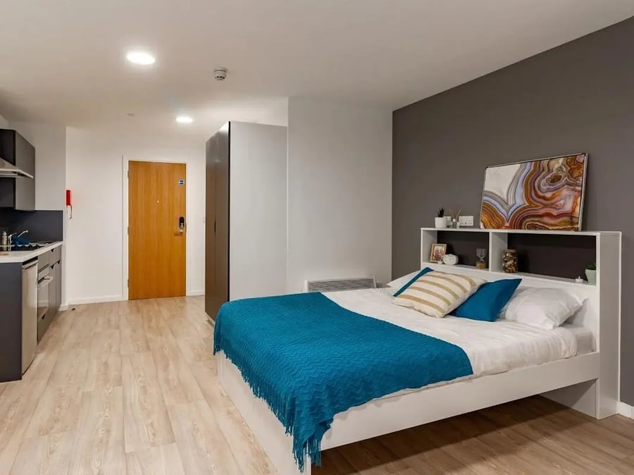 Bed kitchen wardrobe and door student studio at Pavilion Court London in London Student Accommodation