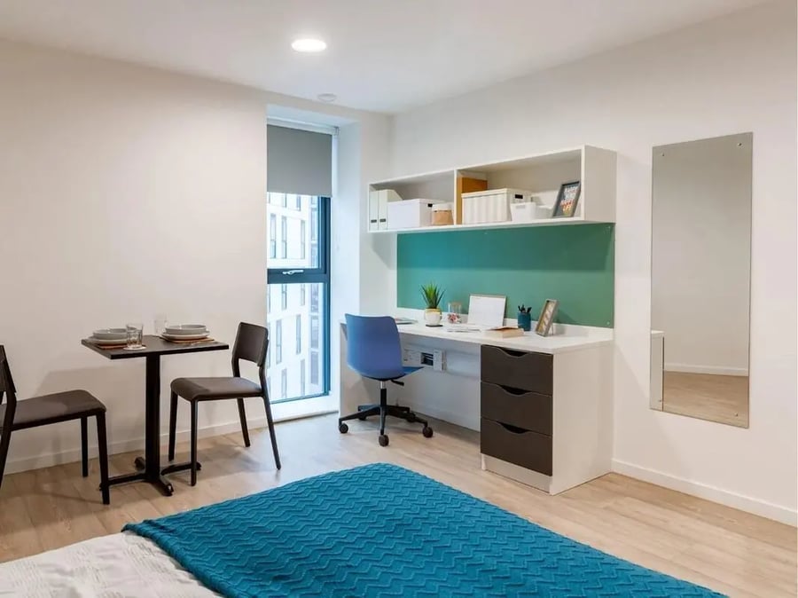 Desk chairs table with place settings modern bedroom at Pavilion Court London in London Student Accommodation