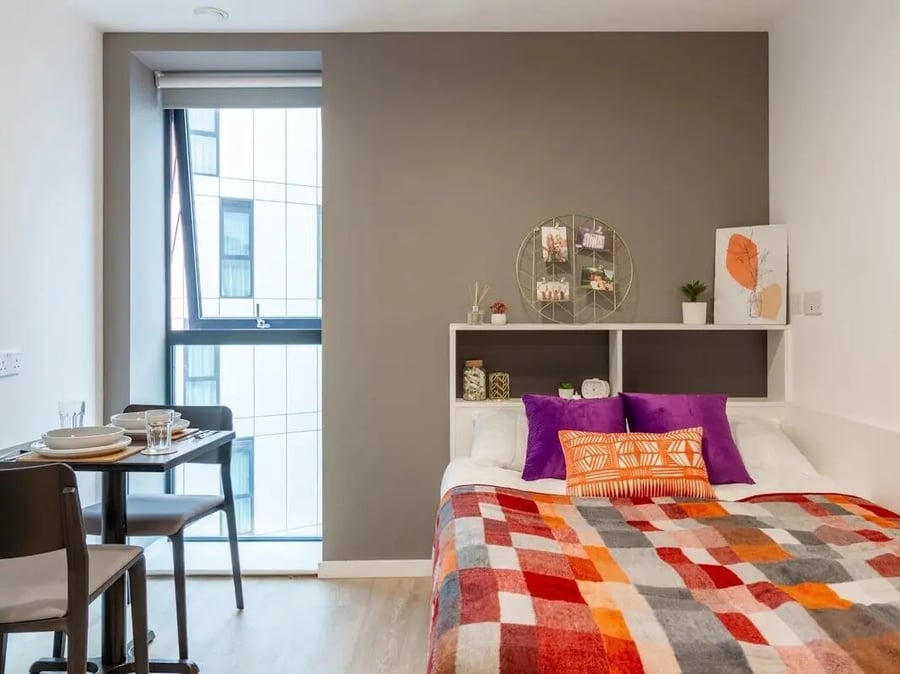 Bed dining table window shelving bedroom at Pavilion Court London in London Student Accommodation