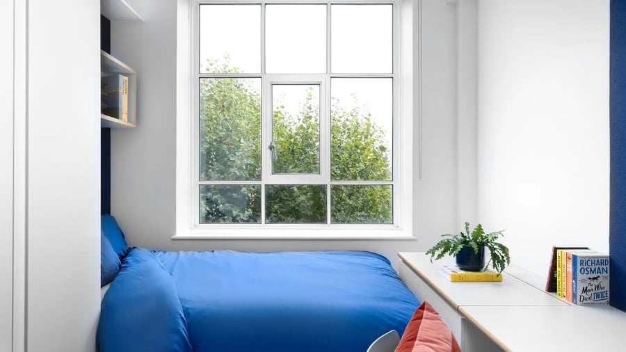 Blue bed shelving and books bedroom at Scape Bloomsbury in London Student Accommodation